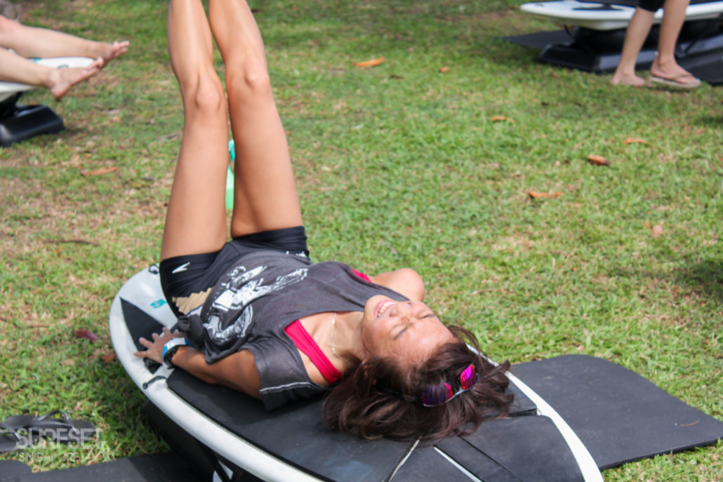 Female participant working core and doing leg raises on SURFSET
